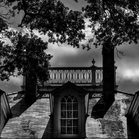 a small clock tower in front of a house