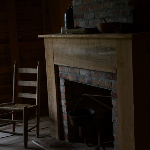 a chair sitting next to a fireplace