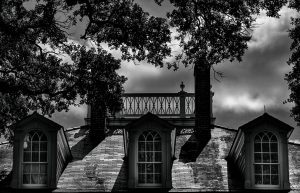 a small clock tower in front of a house