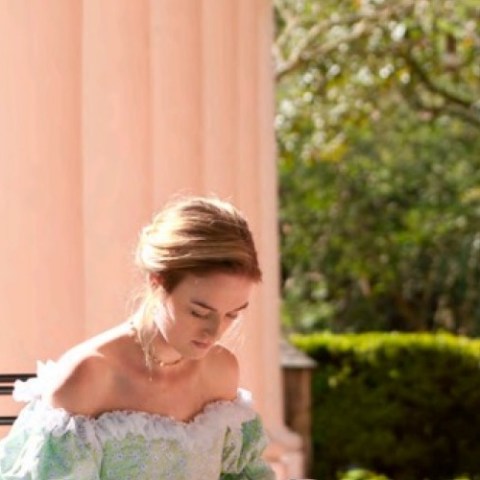 a girl sitting on a bench
